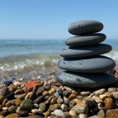 A stack of balanced stones on a calm water background.