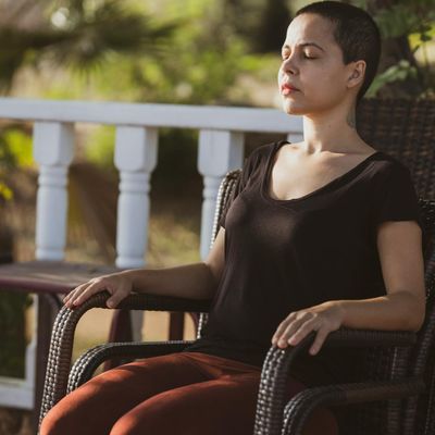 Person practicing deep breathing in a serene environment.